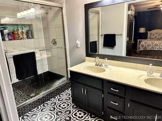 3617 S 74th W Ct, Tulsa, OK 74107 - bathroom with connected bathroom, a stall shower, double vanity, and tile patterned floors