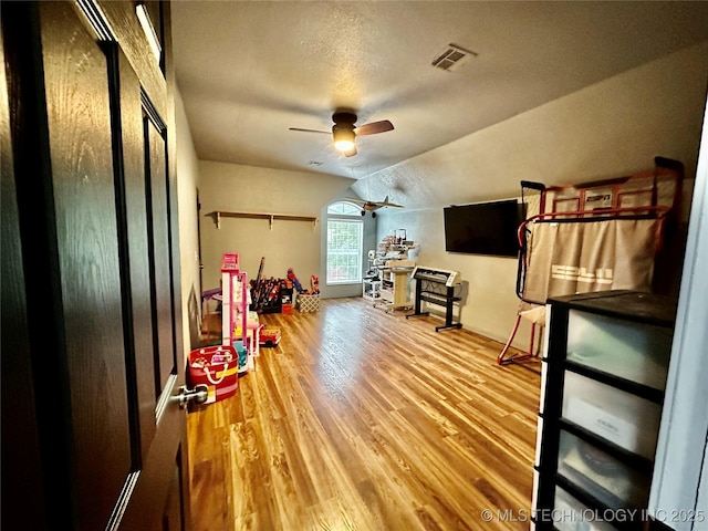 3617 S 74th W Ct, Tulsa, OK 74107 - rec room with a ceiling fan, wood finished floors, lofted ceiling, and a textured ceiling