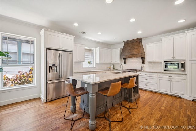 1617 S St Louis Ave, Tulsa, OK 74120 - kitchen with stainless steel appliances, custom exhaust hood, white cabinetry, backsplash, and crown molding