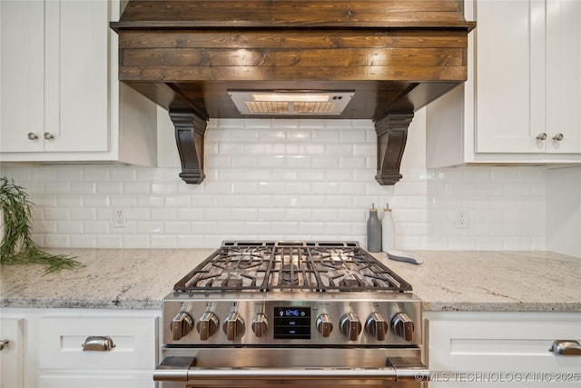 1617 S St Louis Ave, Tulsa, OK 74120 - kitchen with stainless steel gas range oven, custom range hood, white cabinets, and decorative backsplash