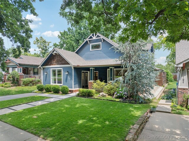 1617 S St Louis Ave, Tulsa, OK 74120 - view of front facade with a porch and a front lawn