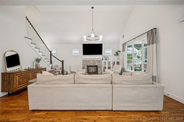 1617 S St Louis Ave, Tulsa, OK 74120 - living area featuring stairway, wood finished floors, a fireplace, and high vaulted ceiling