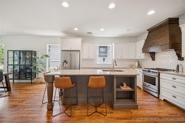 1617 S St Louis Ave, Tulsa, OK 74120 - kitchen featuring stainless steel appliances, white cabinetry, decorative backsplash, ornamental molding, and recessed lighting