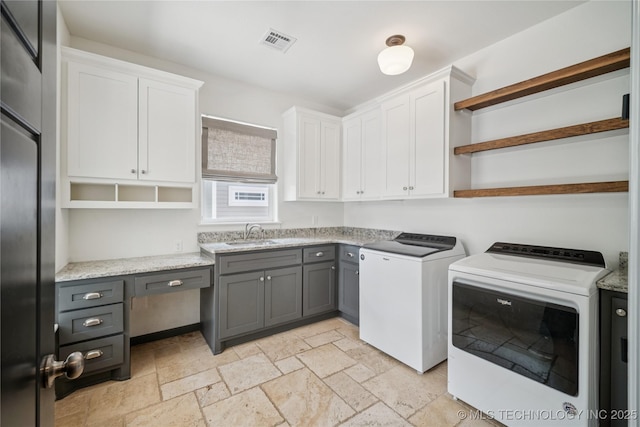 1617 S St Louis Ave, Tulsa, OK 74120 - laundry room with separate washer and dryer, cabinet space, and stone tile floors