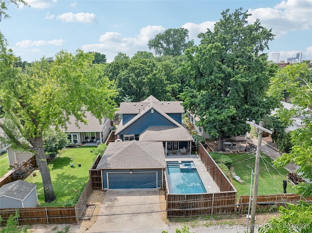 1617 S St Louis Ave, Tulsa, OK 74120 - view of front of house featuring a fenced backyard, a garage, a pool with connected hot tub, and driveway