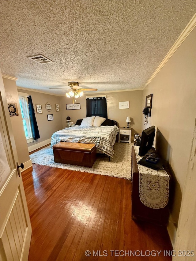 416 E 7th St, Dewey, OK 74029 - bedroom with dark wood-style flooring, crown molding, a textured ceiling, and ceiling fan