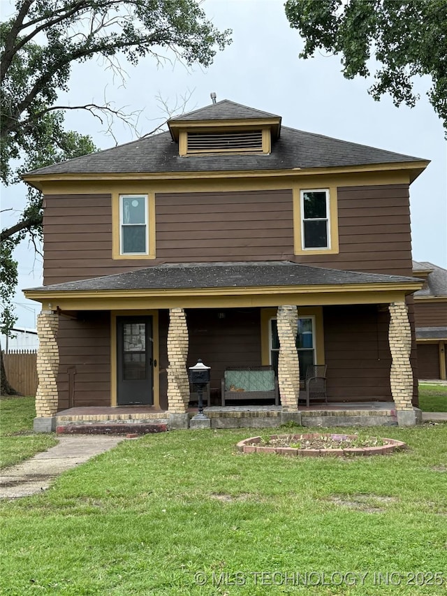 416 E 7th St, Dewey, OK 74029 - back of property featuring covered porch, a lawn, and a shingled roof