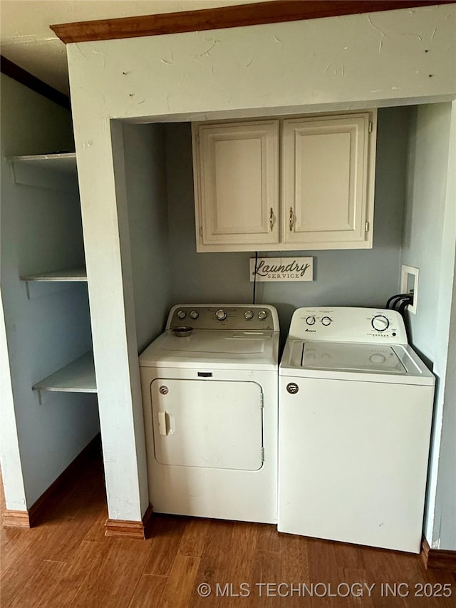 416 E 7th St, Dewey, OK 74029 - laundry room with cabinet space, washing machine and dryer, and wood finished floors
