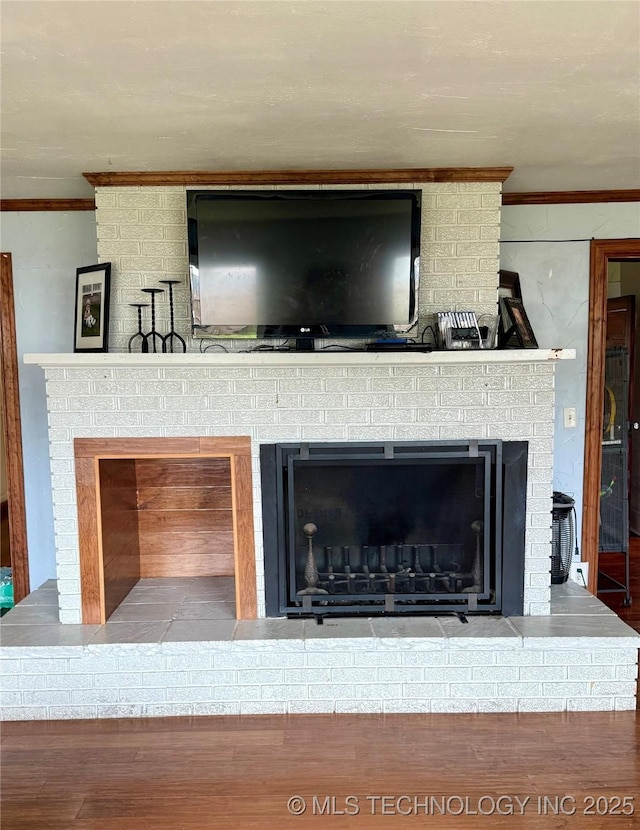 416 E 7th St, Dewey, OK 74029 - detailed view of ornamental molding, a fireplace, and wood finished floors