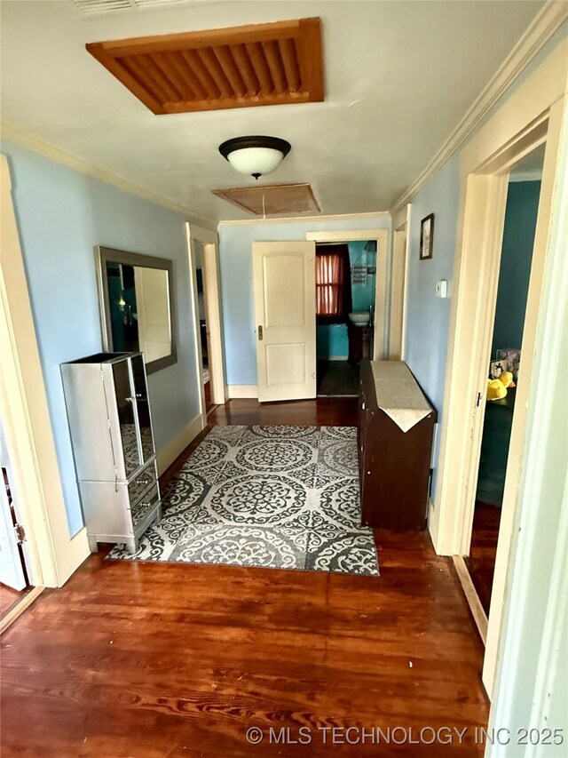 416 E 7th St, Dewey, OK 74029 - hallway featuring crown molding, wood finished floors, and attic access