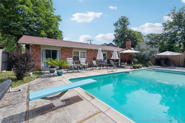 2536 E 57th St, Tulsa, OK 74105 - view of swimming pool featuring a patio area and a diving board