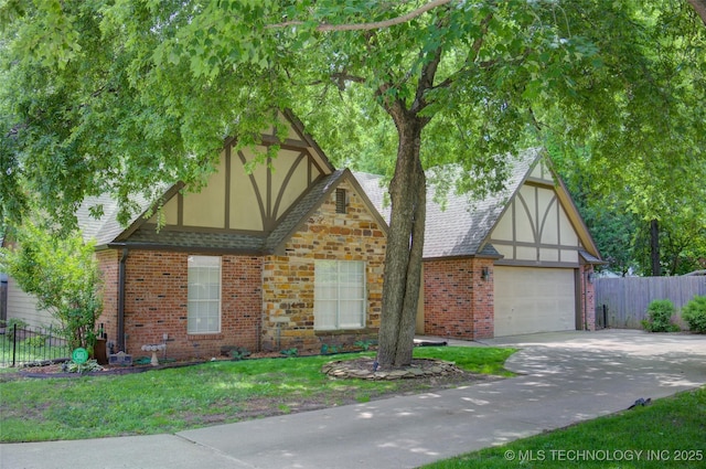 5512 S Columbia Ct, Tulsa, OK 74105 - tudor-style house featuring brick siding, concrete driveway, roof with shingles, and stucco siding