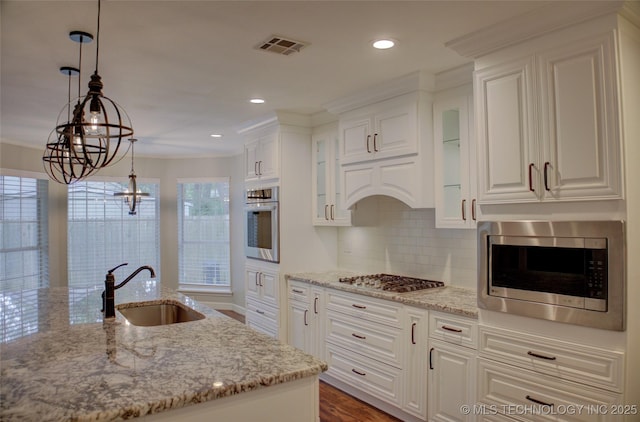 5512 S Columbia Ct, Tulsa, OK 74105 - kitchen featuring stainless steel appliances, white cabinetry, glass insert cabinets, decorative backsplash, and light stone counters