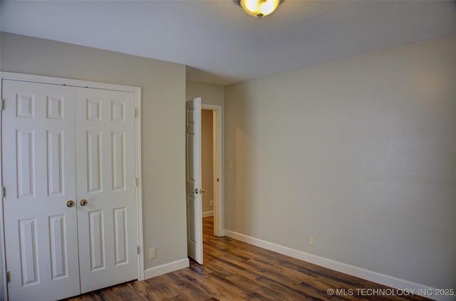 5512 S Columbia Ct, Tulsa, OK 74105 - unfurnished bedroom with dark wood-style flooring and a closet