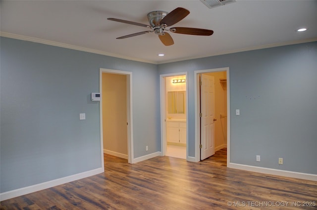5512 S Columbia Ct, Tulsa, OK 74105 - unfurnished bedroom with a walk in closet, crown molding, recessed lighting, wood finished floors, and a closet