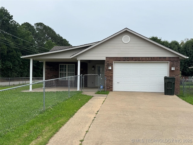 1122 Green St, Sallisaw, OK 74955 - view of front of property featuring driveway, a garage, brick siding, and a gate