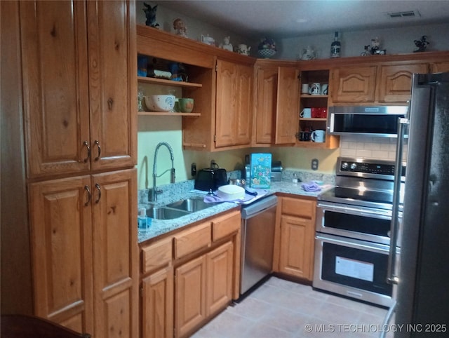 1122 Green St, Sallisaw, OK 74955 - kitchen with open shelves, stainless steel appliances, and light tile patterned flooring