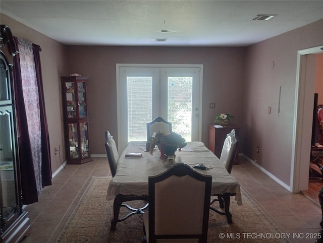 1122 Green St, Sallisaw, OK 74955 - dining space with tile patterned flooring and french doors
