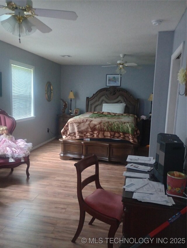 1122 Green St, Sallisaw, OK 74955 - bedroom featuring wood finished floors and ceiling fan