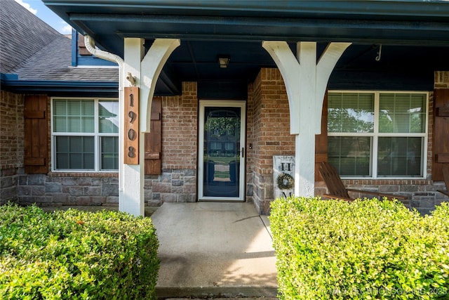 1908 E 133rd Ct, Bixby, OK 74008 - property entrance featuring a porch, stone siding, and roof with shingles