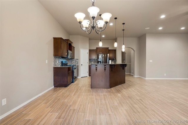 1908 E 133rd Ct, Bixby, OK 74008 - kitchen with stainless steel appliances, a chandelier, backsplash, a kitchen breakfast bar, and dark brown cabinetry