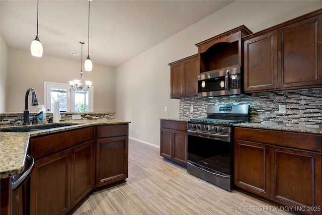 1908 E 133rd Ct, Bixby, OK 74008 - kitchen featuring appliances with stainless steel finishes, tasteful backsplash, a chandelier, hanging light fixtures, and light stone countertops