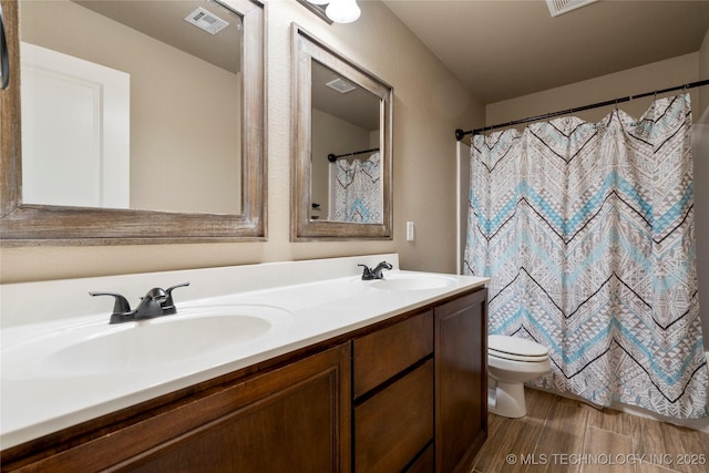 1908 E 133rd Ct, Bixby, OK 74008 - bathroom with double vanity, wood finished floors, and a shower with shower curtain