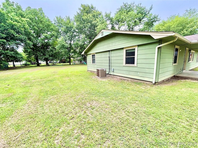 106 E Elk Rd, Whitefield, OK 74472 - view of property exterior featuring a central AC unit and a yard