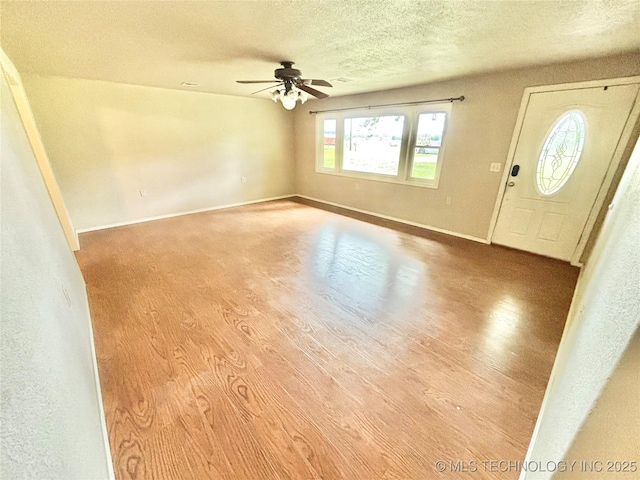 106 E Elk Rd, Whitefield, OK 74472 - foyer entrance featuring wood finished floors, a textured ceiling, and ceiling fan