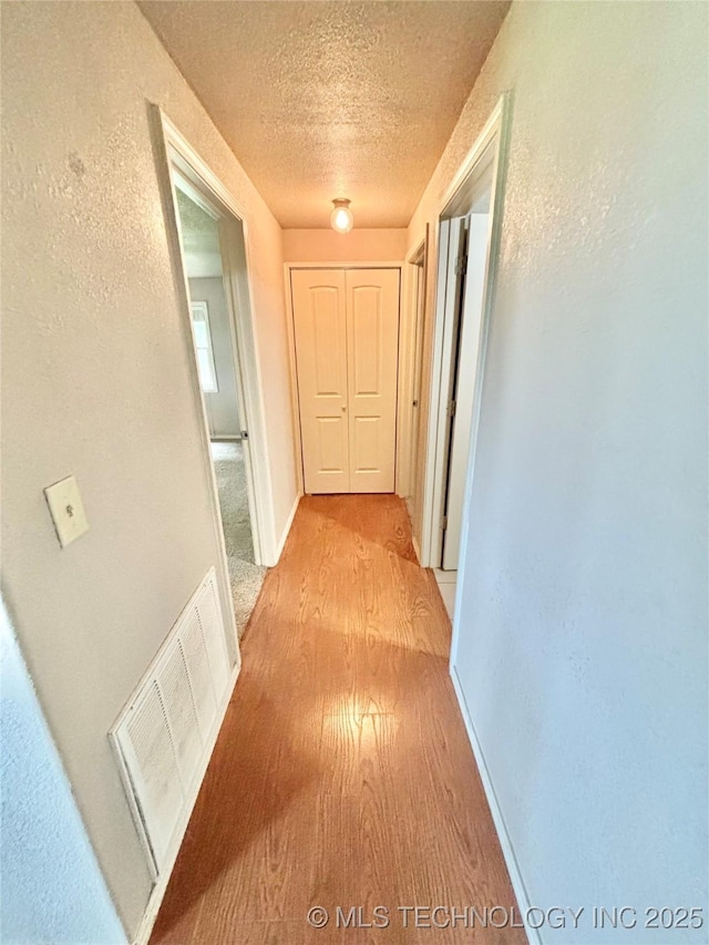 106 E Elk Rd, Whitefield, OK 74472 - hall featuring light wood-type flooring and a textured ceiling