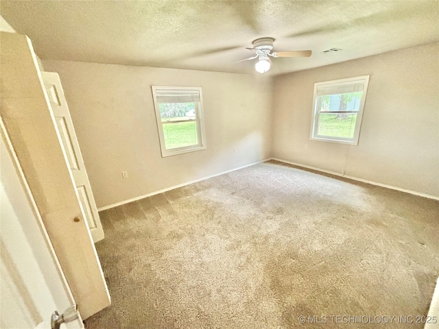 106 E Elk Rd, Whitefield, OK 74472 - carpeted spare room featuring healthy amount of natural light, a ceiling fan, and a textured ceiling