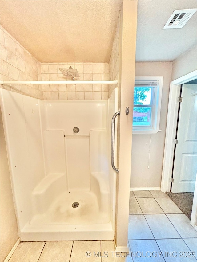 106 E Elk Rd, Whitefield, OK 74472 - bathroom featuring tile patterned floors, a shower, and a textured ceiling