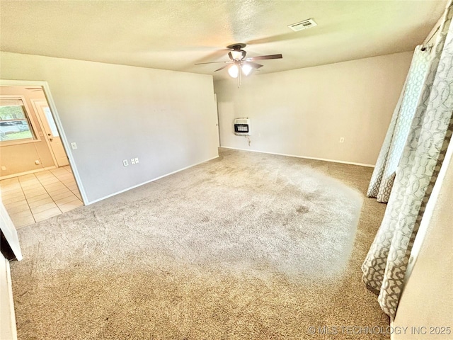 106 E Elk Rd, Whitefield, OK 74472 - tiled spare room with carpet floors, a ceiling fan, heating unit, and a textured ceiling