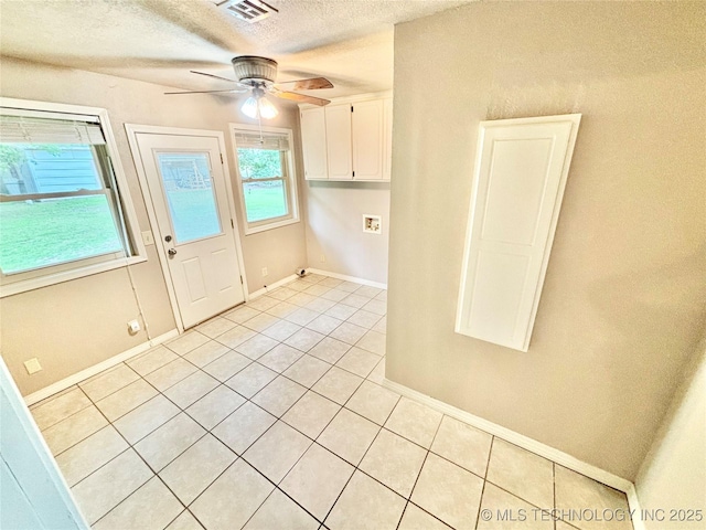 106 E Elk Rd, Whitefield, OK 74472 - kitchen with light tile patterned floors, white cabinets, a ceiling fan, and a textured ceiling