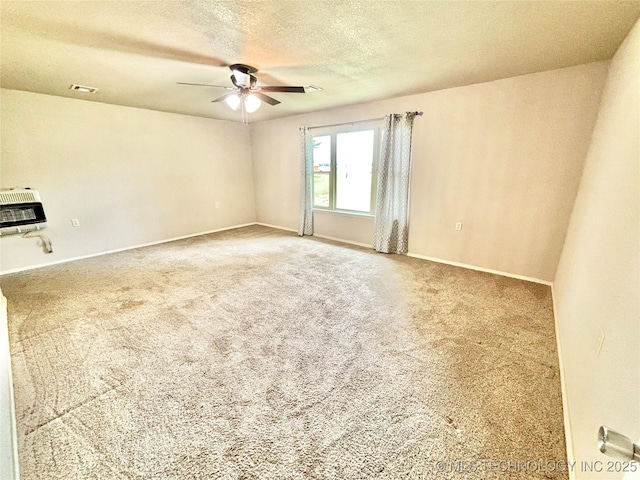 106 E Elk Rd, Whitefield, OK 74472 - spare room with ceiling fan, heating unit, a textured ceiling, and carpet flooring