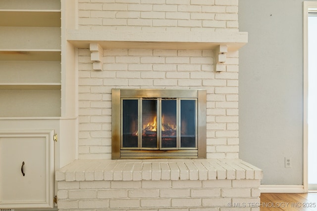 8202 S Ash Pl, Broken Arrow, OK 74011 - detailed view of wood finished floors and a fireplace