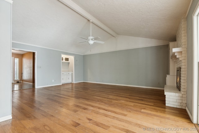 8202 S Ash Pl, Broken Arrow, OK 74011 - unfurnished living room featuring ceiling fan, light wood-type flooring, a fireplace, and a textured ceiling