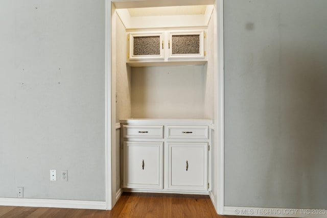 8202 S Ash Pl, Broken Arrow, OK 74011 - detailed view of wood finished floors and baseboards