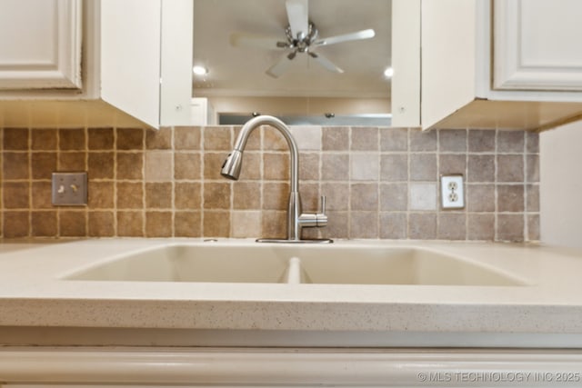 8202 S Ash Pl, Broken Arrow, OK 74011 - kitchen view of light countertops, white cabinetry, backsplash, and ceiling fan