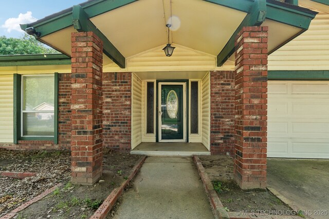 8202 S Ash Pl, Broken Arrow, OK 74011 - view of exterior entry with brick siding and an attached garage