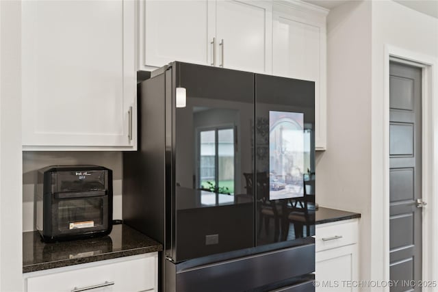 3117 W Winston St, Broken Arrow, OK 74011 - kitchen featuring fridge, white cabinets, and dark stone countertops