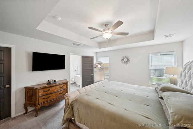 3117 W Winston St, Broken Arrow, OK 74011 - bedroom featuring a tray ceiling, light colored carpet, multiple windows, and connected bathroom