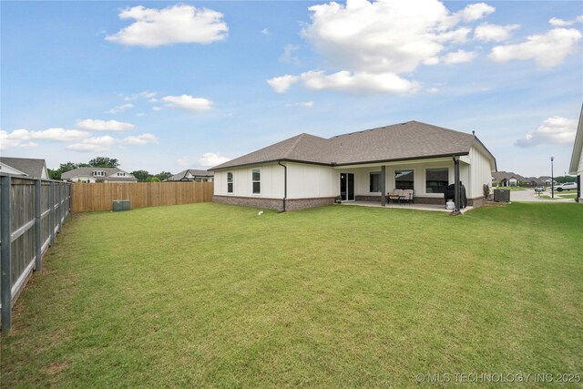 3117 W Winston St, Broken Arrow, OK 74011 - back of house featuring a fenced backyard, a patio, a shingled roof, and brick siding