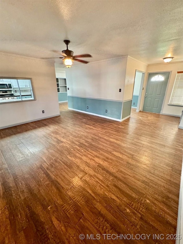 5101 S Spruce Dr, Sand Springs, OK 74063 - unfurnished living room featuring a textured ceiling, hardwood / wood-style flooring, ceiling fan, and crown molding