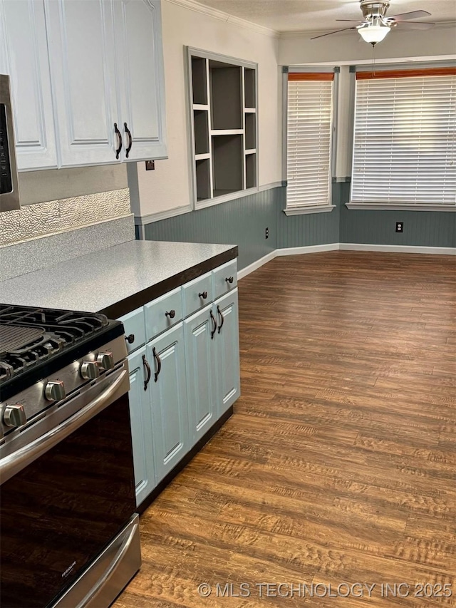 5101 S Spruce Dr, Sand Springs, OK 74063 - kitchen with stainless steel gas range, dark wood-style floors, ceiling fan, wainscoting, and ornamental molding