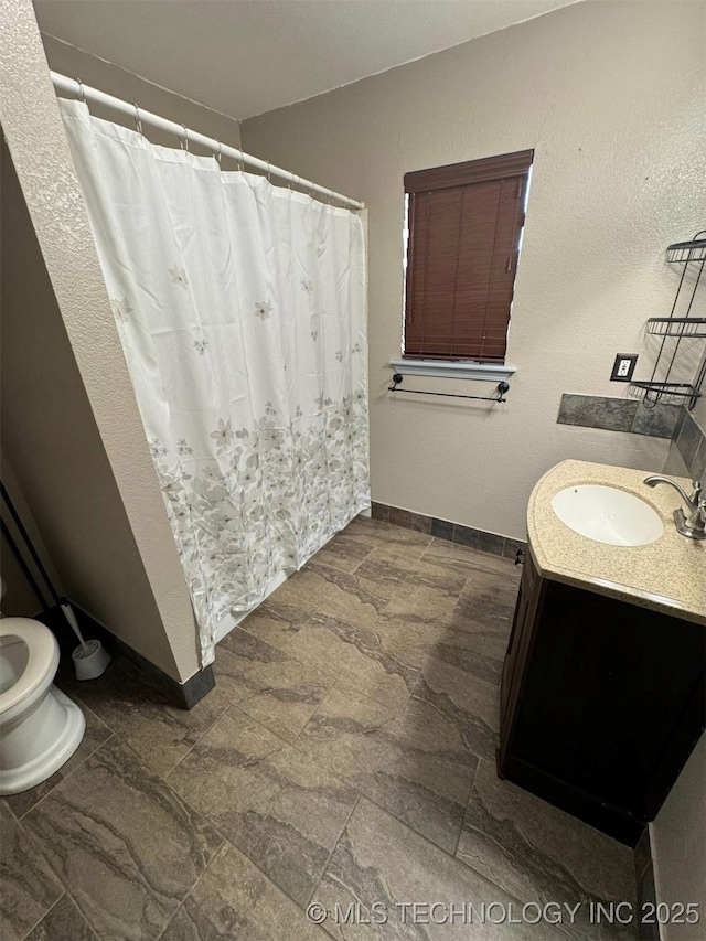 5101 S Spruce Dr, Sand Springs, OK 74063 - full bathroom featuring vanity, stone finish floors, and curtained shower