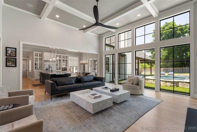 3207 E 44th St, Tulsa, OK 74105 - living area with a towering ceiling, coffered ceiling, plenty of natural light, light wood finished floors, and a chandelier