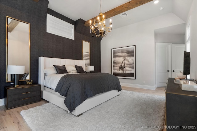 3207 E 44th St, Tulsa, OK 74105 - bedroom featuring a chandelier, wood finished floors, an accent wall, and vaulted ceiling