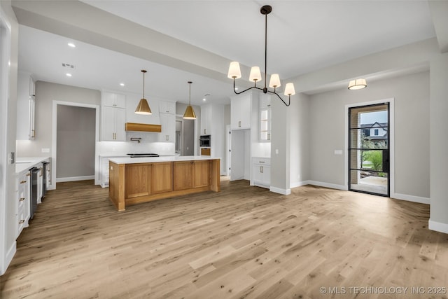 6364 N Blue Sage Dr, Owasso, OK 74055 - kitchen featuring light wood-type flooring, recessed lighting, white cabinets, light countertops, and a kitchen island