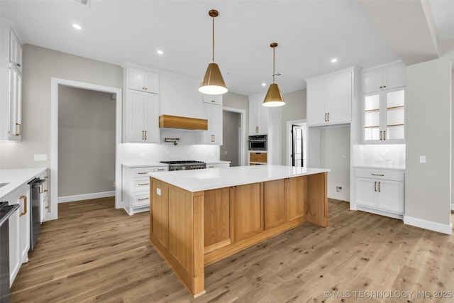 6364 N Blue Sage Dr, Owasso, OK 74055 - kitchen with tasteful backsplash, light wood finished floors, white cabinets, and recessed lighting